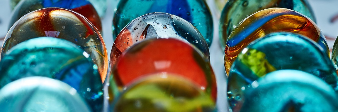 Multi-colored marbles stacked in columns
