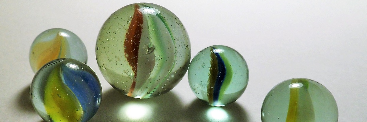 5 marbles of varied size and color